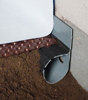 Closeup of a crawl space drainage system installed in Circleville