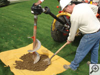 Auguring a hole in the earth for a foundation repair in Mansfield