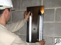 Mounting a foundation wall plate for an earth anchor installation in Galloway.