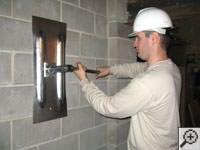 Attempting to straighten a bowed foundation wall by straightening a wall anchor system in a Reynoldsburg home.