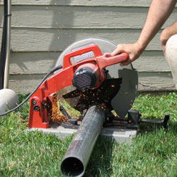 Cutting the support beam for a crawl space jack post outside a Galloway home.