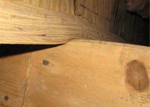 A failing girder showing signs of compression damage in a Washington Court House home