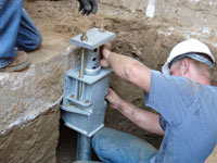 Foundation repair contractors installing the foundation bracket in Chillicothe.