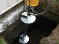 Installing a helical pier system in the earth around a foundation in Delaware