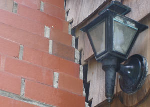 A tilting chimney in Grove City showing serious foundation damage.