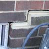 A closeup of a failed tuckpointing job where the brick cracked on a Powell home.