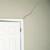 A long drywall crack beginning at the corner of a doorway in a Portsmouth home.