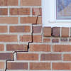 long jagged cracks starting at the corner of a window along a brick wall on a Blacklick home