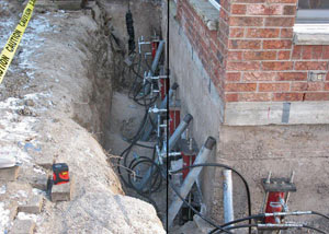 Foundation push piers installed around a house with a foundation settlement issues in Marietta