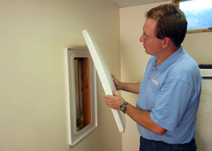 Foundation wall anchor covers installed in a finished basement with a repaired foundation wall in Marietta.