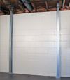 A steel i-beam system installed on a Powell foundation wall
