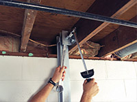 Straightening a foundation wall with the PowerBrace™ i-beam system in a Springfield home.