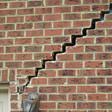 stair step cracking reaching from a window along the foundation wall in Westerville
