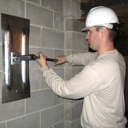 installing a wall anchor to repair an bowing foundation wall in Springfield