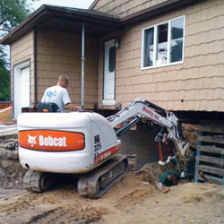 Excavating to expose the foundation walls and footings for a replacement job in Mansfield