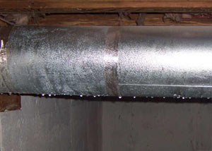 condensation collecting on an HVAC vent in a humid Zanesville basement