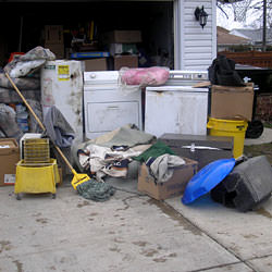 Soaked, wet personal items sitting in a driveway, including a washer and dryer in Reynoldsburg.