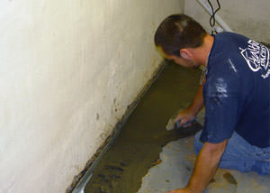 Restoring a concrete slab floor with fresh concrete after jackhammering it and installing a drain system in Pataskala.