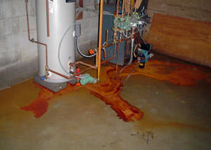 Iron ochre water on a concrete basement floor, staining everything
