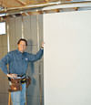 Installing wall panels on top of our basement wall insulation in Newark