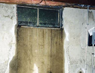Water pouring out from a basement window in Westerville